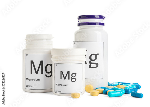 Obraz na płótnie Different bottles with magnesium pills on white background