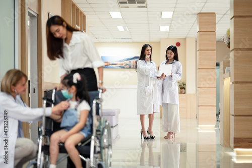 Parents or mothers take their daughters in wheelchairs to a doctor or scientist. to check the body to find the cause of the illness in the hospital