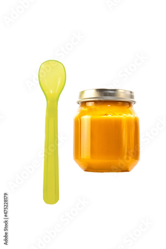 baby food in a jar isolate. baby puree in a transparent glass jar on a white background. fruit baby puree with spoon
