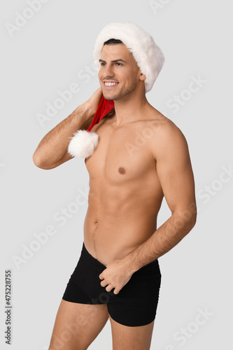 Sexy young man in Santa hat...