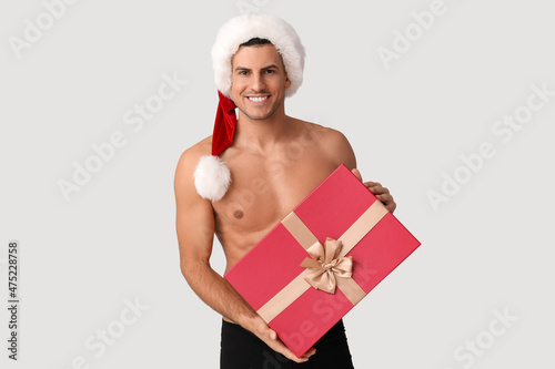 Sexy young man in Santa hat...
