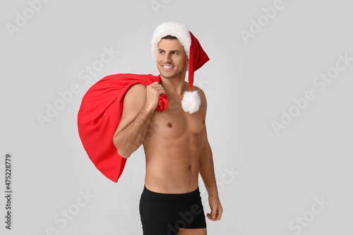 Sexy young man in Santa hat...