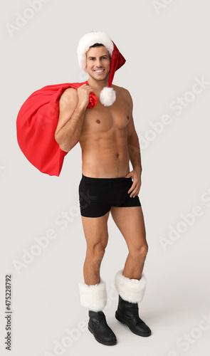 Sexy young man in Santa hat...