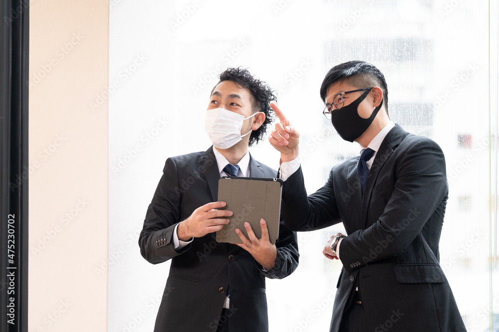 Executive Asian businessmen meeting by the window, copy space available, masks available. Executive Asian businessmen meeting by the window, copy space available, masks available.