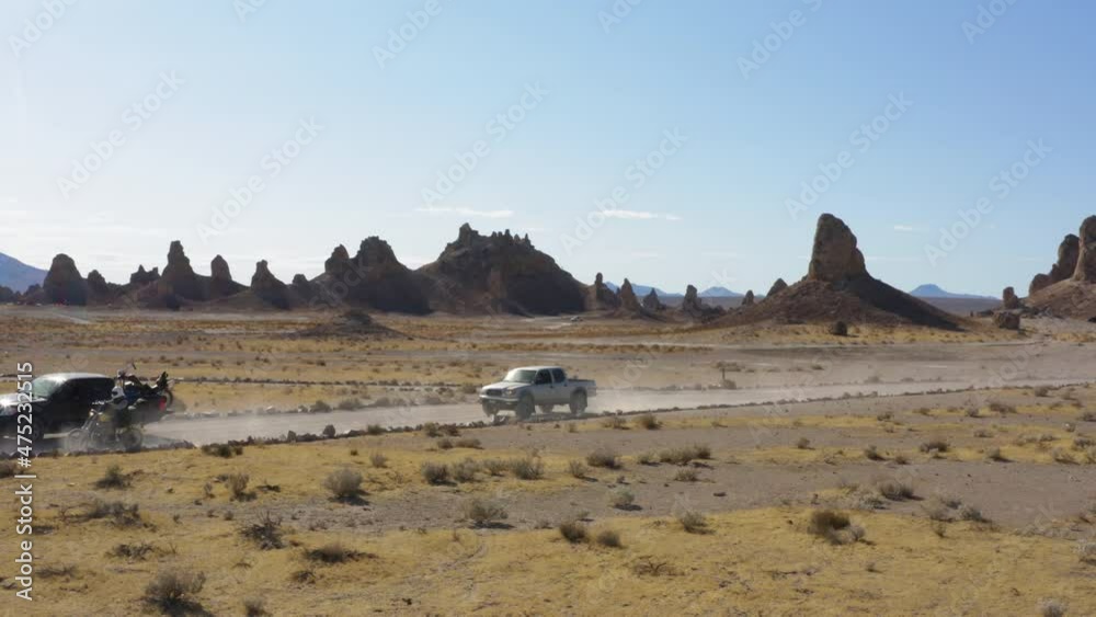 Trona Pinnacles In Mojave Desert California Rock Formations Sunset.Harley Motorcycles panning aerial view. Tufa spires at dusk. Unique geological features in the Mojave Desert Trona Pinnacles In Mojave Desert California Rock Formations Sunset.Harley Motorcycles panning aerial view. Tufa spires at dusk. Unique geological features in the Mojave Desert