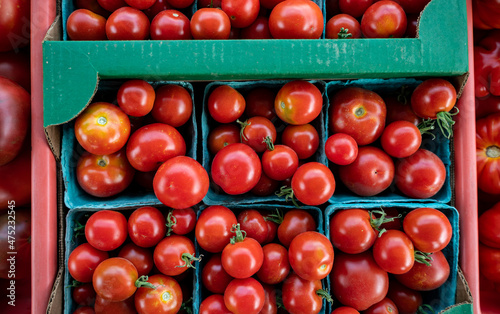 Fresh  shiny heirloom tomatoes are on piled up and on display at a Farmers Market in Oregon