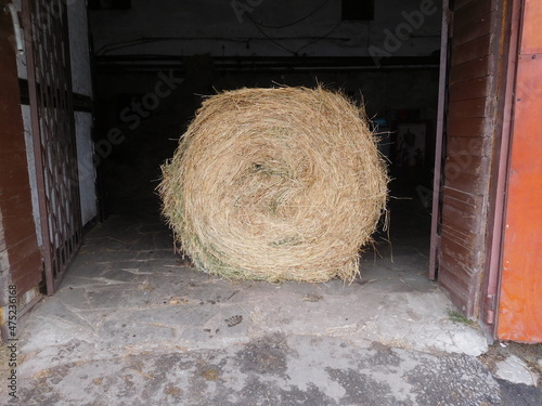 bale of hay in the open stable gate, hayroll  photo