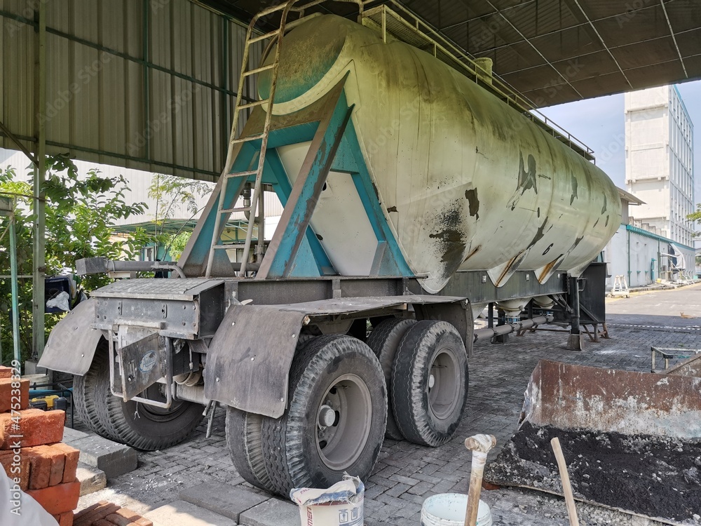 Dirty wheat flour delivery truck tank that is parked Dirty wheat flour delivery truck tank that is parked