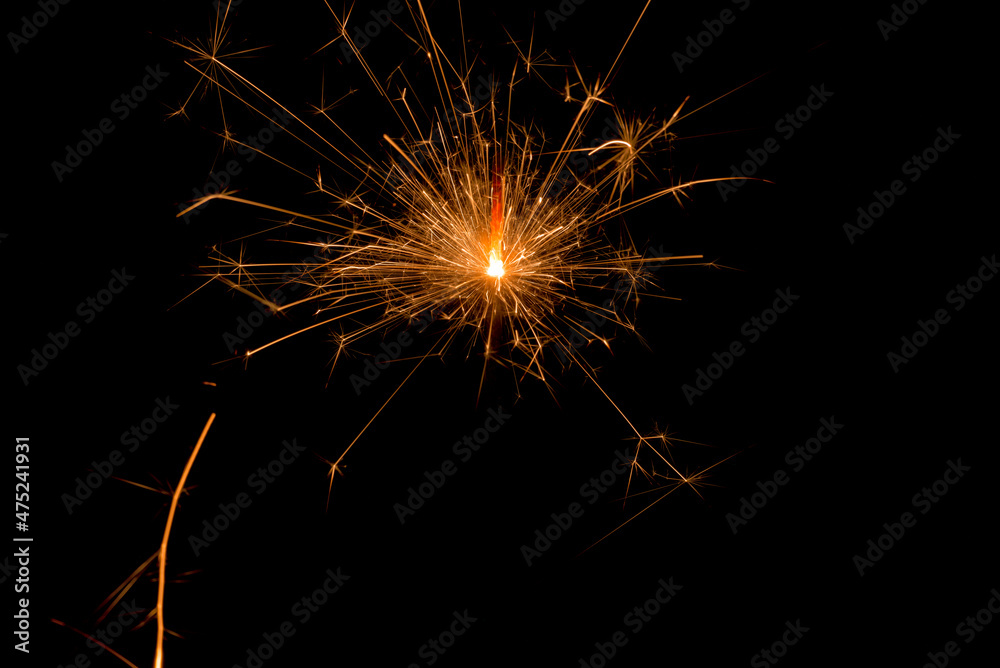 Shinny sparkling bengal lights on a black background. Christmas new year birthday celebration concept. Fireworks pyrotechnics