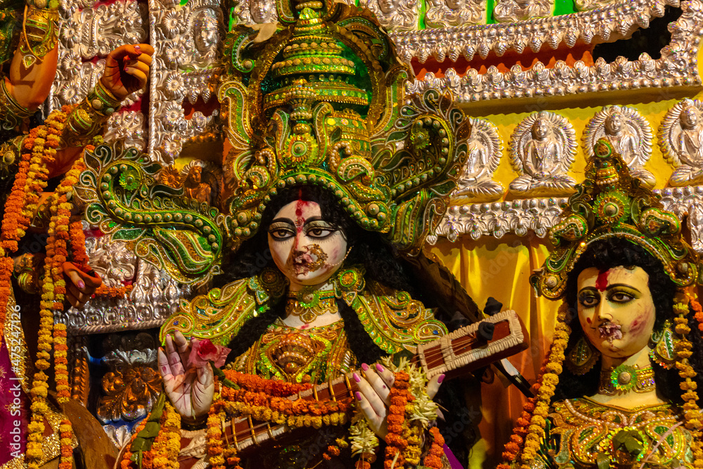 Statue of Goddess Saraswati holding a musical Instrument called Veena, clicked during Dussehra festival Kolkata, West Bengal, India. Statue of Goddess Saraswati holding a musical Instrument called Veena, clicked during Dussehra festival Kolkata, West Bengal, India.