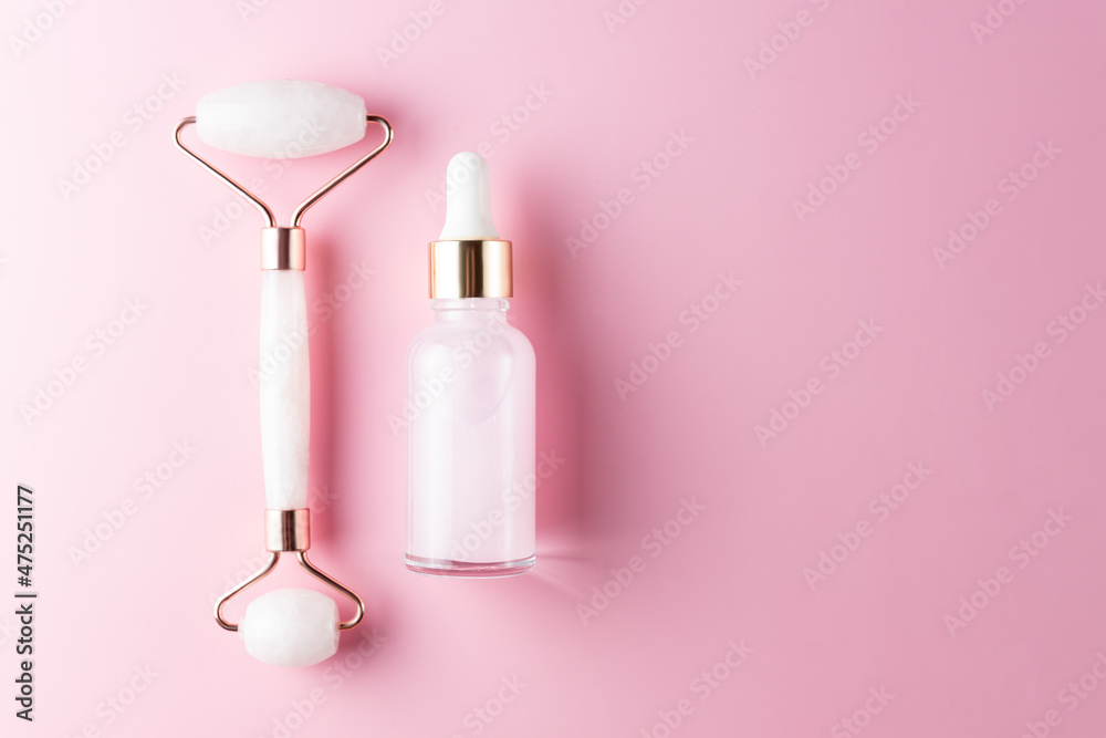 Massage quartz roller for the face of pink natural nephritis with beauty serum or essential oil. Skin care facial massage and relaxation. Home massage tools. Anti age and lifting procedures. Massage quartz roller for the face of pink natural nephritis with beauty serum or essential oil. Skin care facial massage and relaxation. Home massage tools. Anti age and lifting procedures.