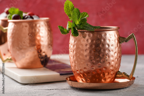 Photography Traditional american alcoholic beverage moscow mule in copper mugs with cranberr