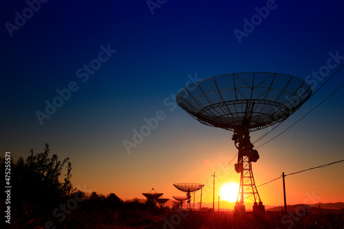 The silhouette of a radio telescope observatory