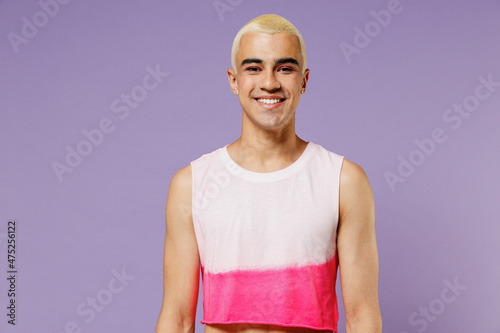 Young trendy blond hispanic latin gay man 20s with make up in fashionable bright pink top look camera isolated on plain pastel purple background studio portrait People lifestyle fashion lgbtq concept photo