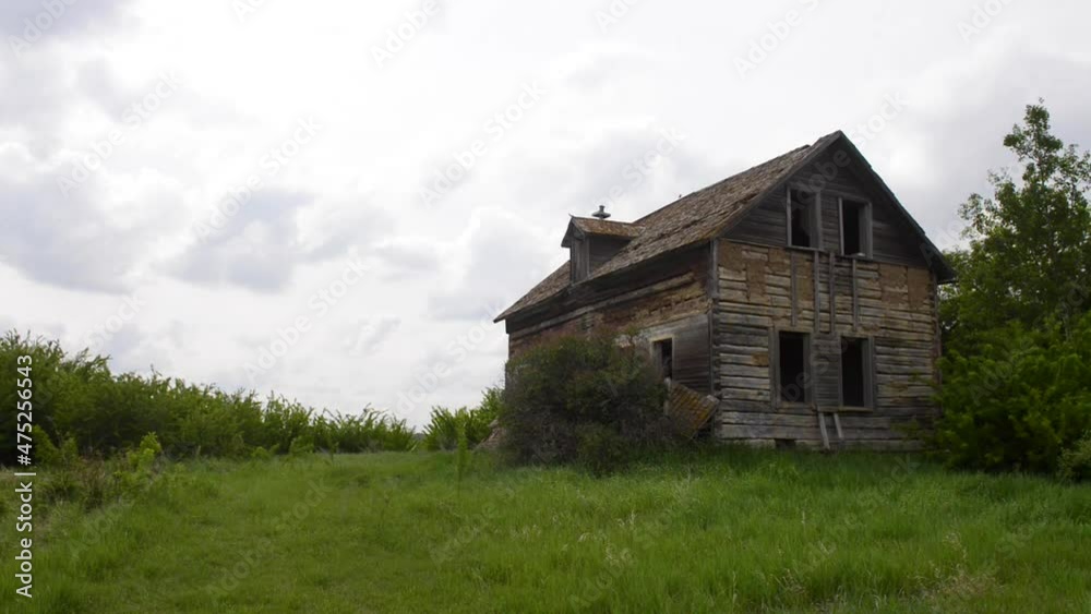 Exploring the ruins of an derelict abandoned rural farmhouse in an overgrown field of the Alberta prairies in western Canada. Exploring the ruins of an derelict abandoned rural farmhouse in an overgrown field of the Alberta prairies in western Canada.