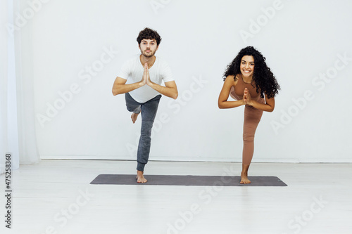 man and woman engaged in yoga asana gymnastics