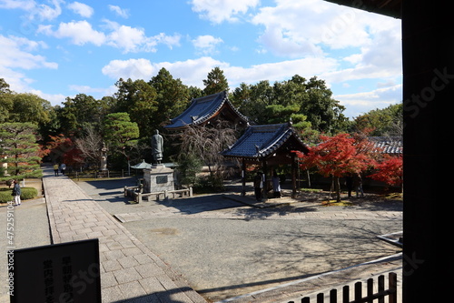 Chouzuya and sho-ro Belfry and the image of Hounenshonin and autumn leaves in the the precincts of Koumyou-ji Temple in Nagaokakyou City in Kyoto prefecture in Japan 日本の京都府長岡京市にある光明寺境内の手水舎と鐘楼と法然上人像と紅葉 photo