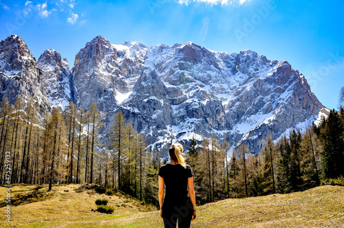 Young woman traveler standing in front of mighty mountains, the highest pass in Slovenia - Vršič Pass, Europe photo