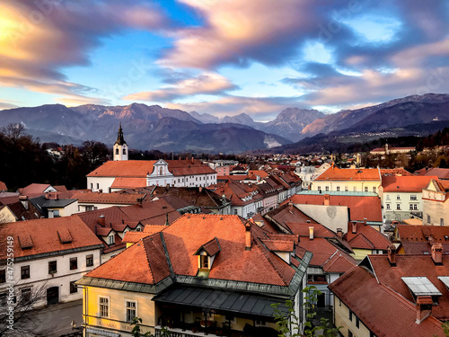 Magical sky and the red roofs of the town of Kamnik under the Kamnik-Savinja Alps , Slovenia photo