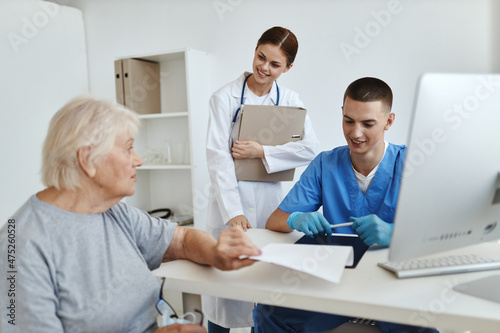 elderly woman patient at hospital appointment nurse and doctor health care