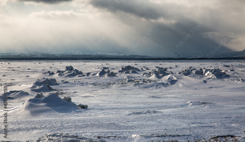 Frozen sea with mountains at sunset Frozen sea with mountains at sunset