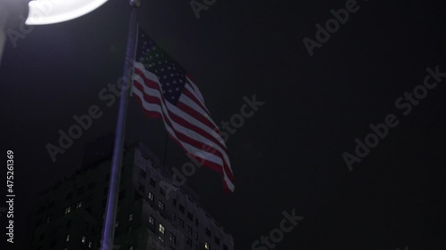 American Flag Waving In Slow-Motion In Nighttime New York City.
