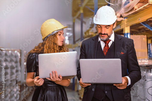 Manager and supervisor discussing work with products in stock and ready to delivery. 