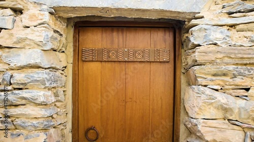 Establishing shot of antique wooden door in Thee Ain village Saudi Arabia, old carpentry design 