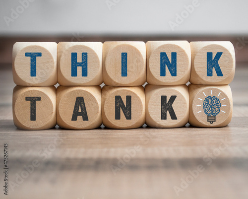 Cubes, dice or blocks with with message think tnk with brain light bulb on wooden background photo