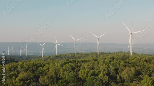 Nakhon Ratchasima/ Thailand-December 6: Rows of EGAT windmills on December 6, 2021. Windmills on the hill convert wind energy to electricity to supply alternative source for electrical usage. photo