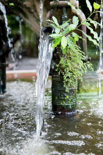 Old water pump with many moss, focus selective.