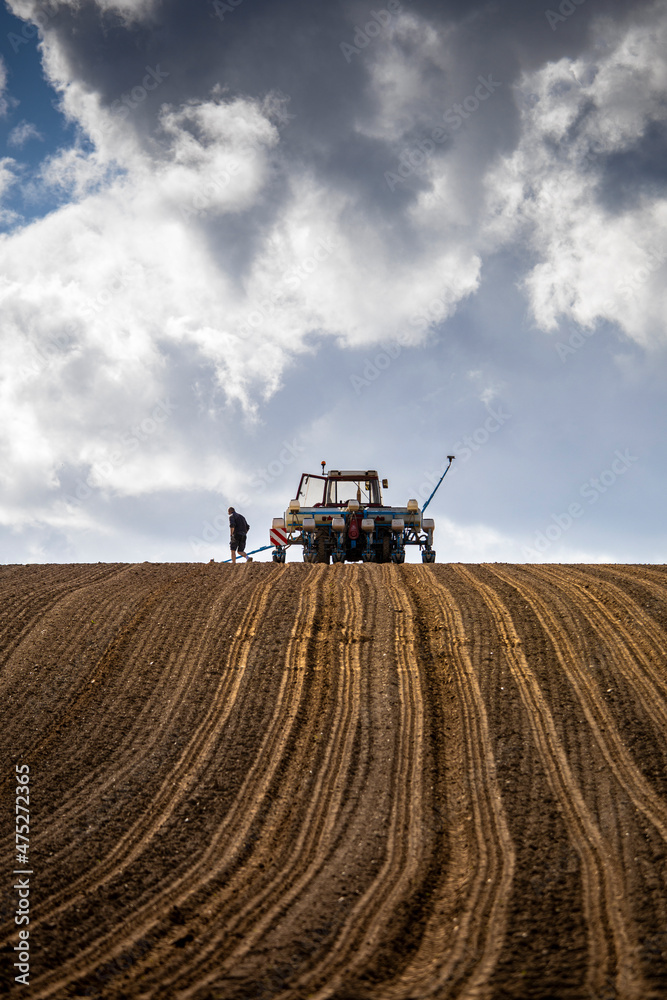 Fototapeta premium Paysage agricole et fermier au milieu de son champ pendant les semences.