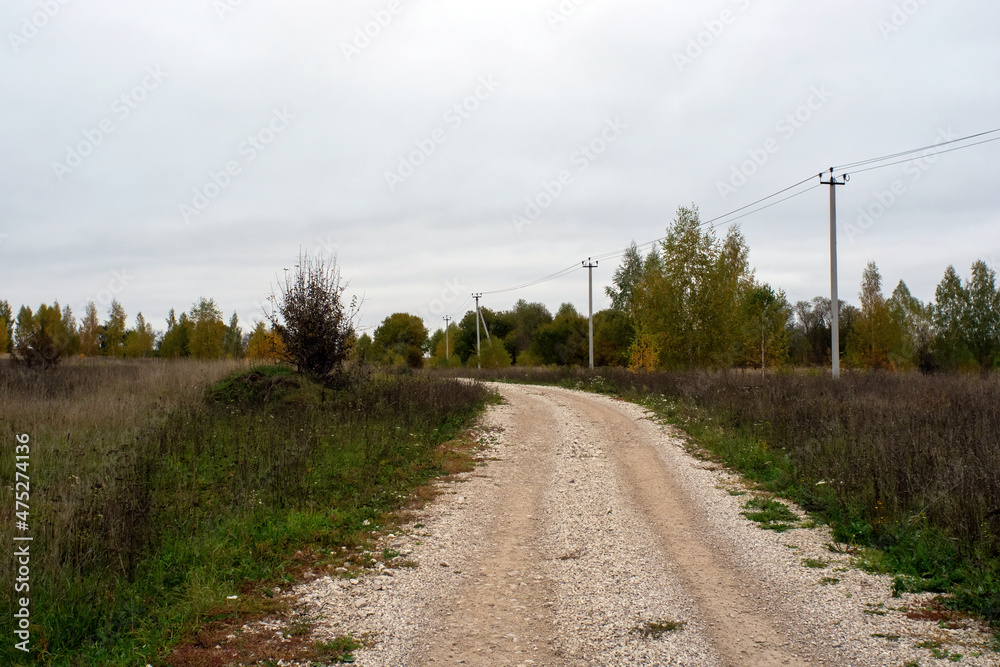 a rural road of gravel on a cloudy day