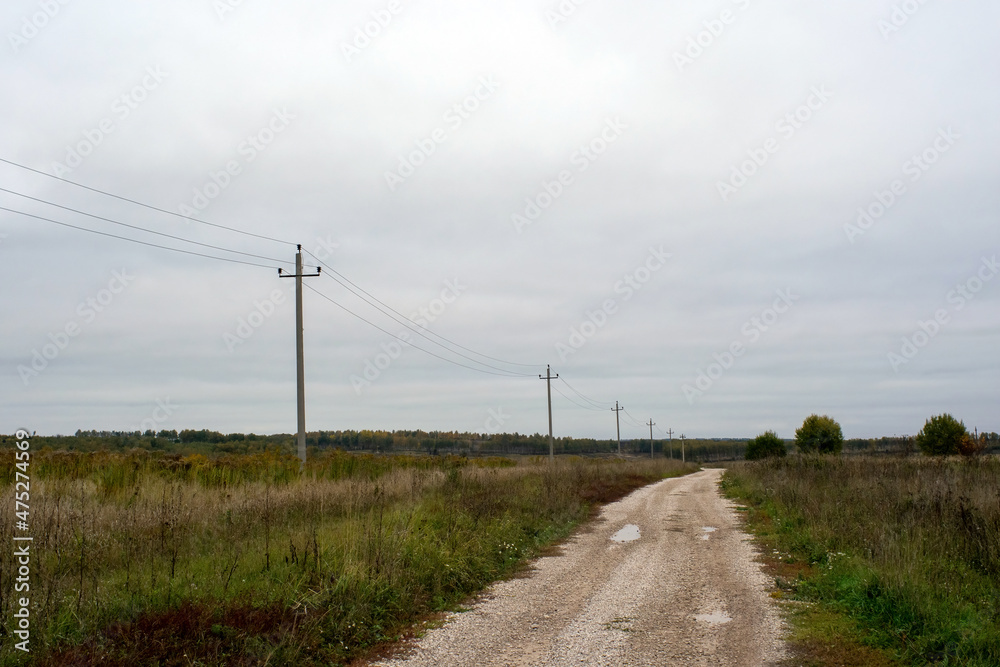 a rural road of gravel on a cloudy day a rural road of gravel on a cloudy day