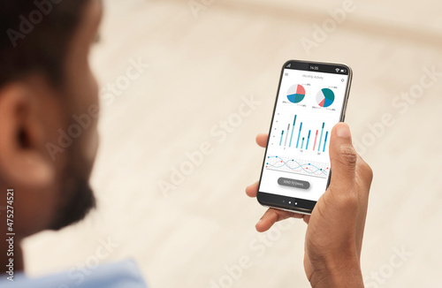 Cropped of black man using analytics mobile app on smartphone