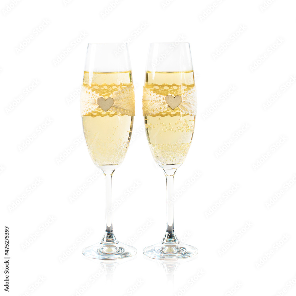 Two glasses of champagne decorated for the wedding with lace and wooden heart. Two glasses of champagne decorated for the wedding with lace and wooden heart.