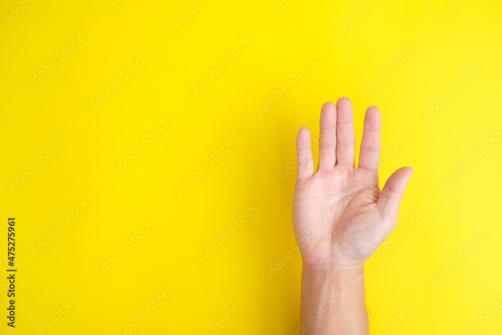 close up hand on yellow background close up hand on yellow background