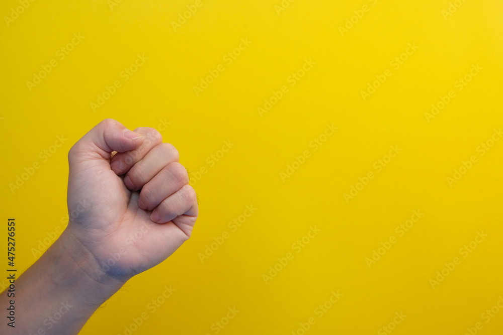 Naklejka premium close up hand on yellow background