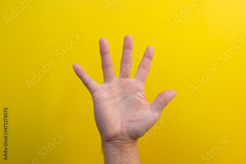 close up hand on yellow background