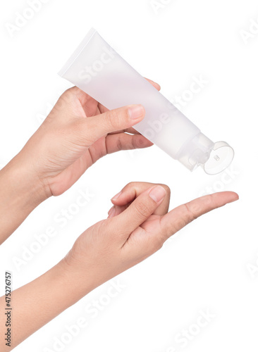 Hand holding blank squeeze bottle plastic tube isolated on white background.