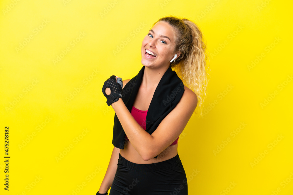 Sport woman with towel isolated on yellow background celebrating a victory Sport woman with towel isolated on yellow background celebrating a victory