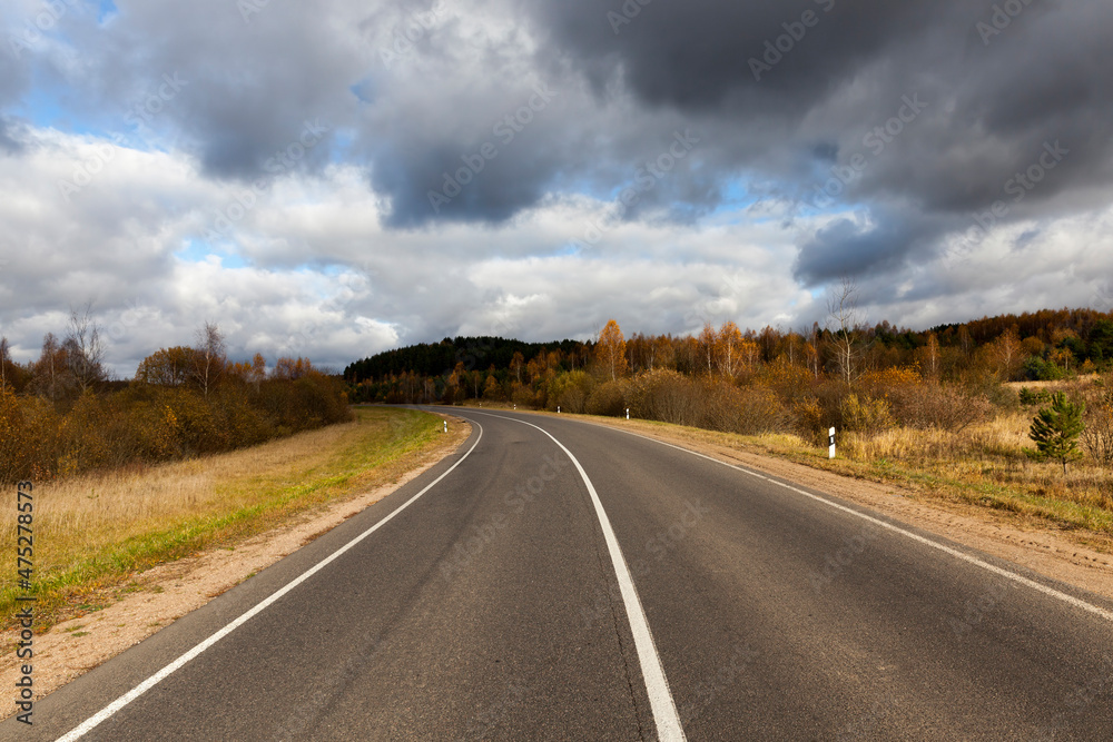 an asphalt road in the autumn season