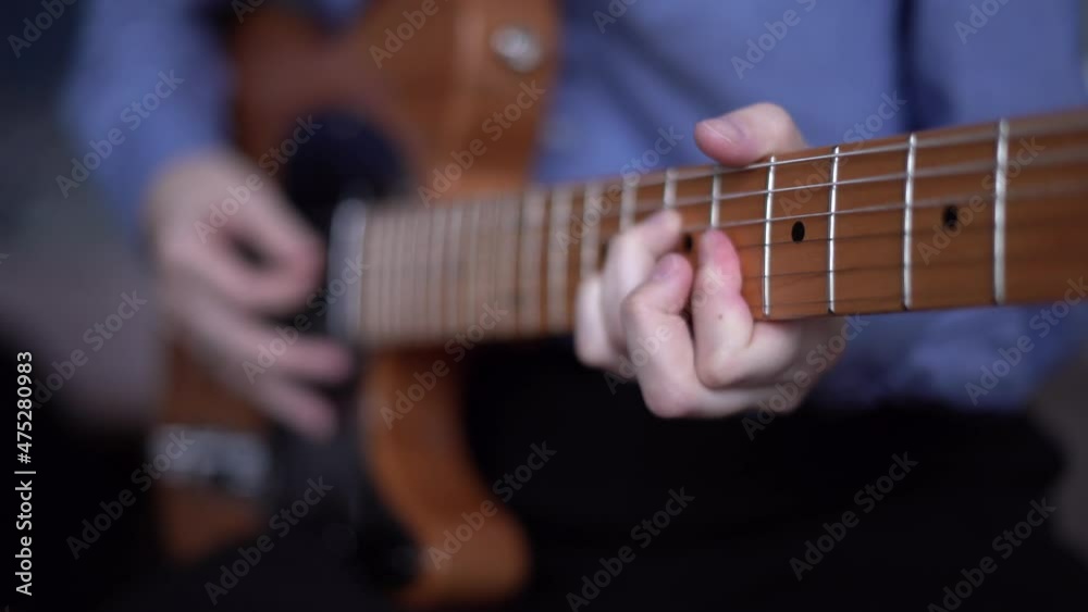Guitar player hands playing telecaster with pick. Pop rock riff on electric guitar, distance music learning for people all ages. Concept of art education Guitar player hands playing telecaster with pick. Pop rock riff on electric guitar, distance music learning for people all ages. Concept of art education