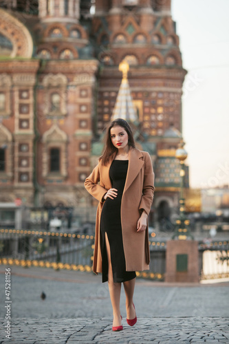 girl in coat in the street at sunrise