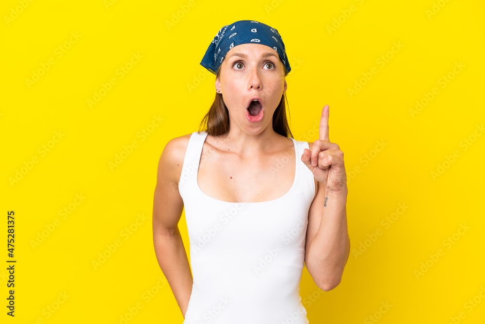 Young English woman isolated on yellow background thinking an idea pointing the finger up Young English woman isolated on yellow background thinking an idea pointing the finger up