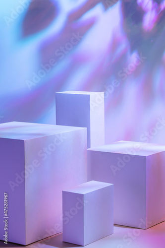Abstract surreal scene - empty stage with four rectangle white podiums on pastel holographic background with plant shadows. Pedestal for cosmetic product packaging mockups display presentation