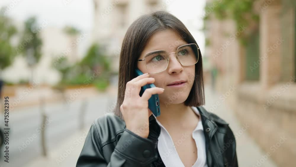 Young hispanic woman smiling confident talking on the smartphone at street Young hispanic woman smiling confident talking on the smartphone at street
