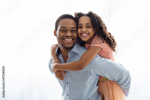 Fotografie, Obraz Cute black father and daughter bonding over white