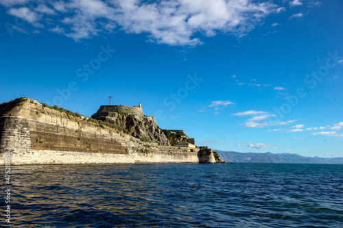 	
Corfu Castle old fort Greek island surrounded by blue sea sky and mountains a tourist attraction in Mediterranean Greece.	
