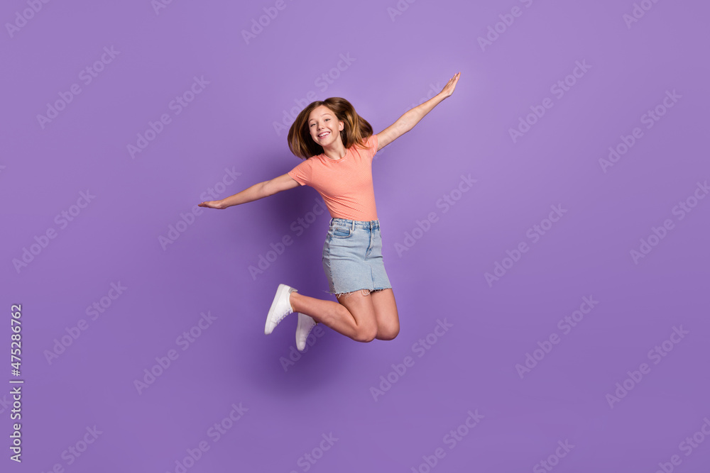 Full length body size view of attractive cheerful funky girl jumping flying like plane isolated on bright violet purple color background